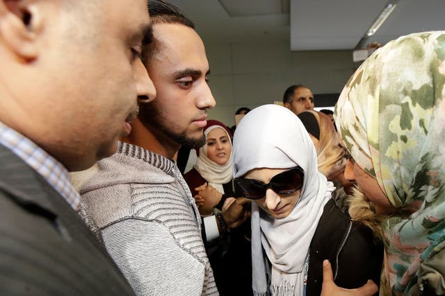 Shaima Swileh stands with her husband Ali Hassan after she arrived at San Francisco International Airport