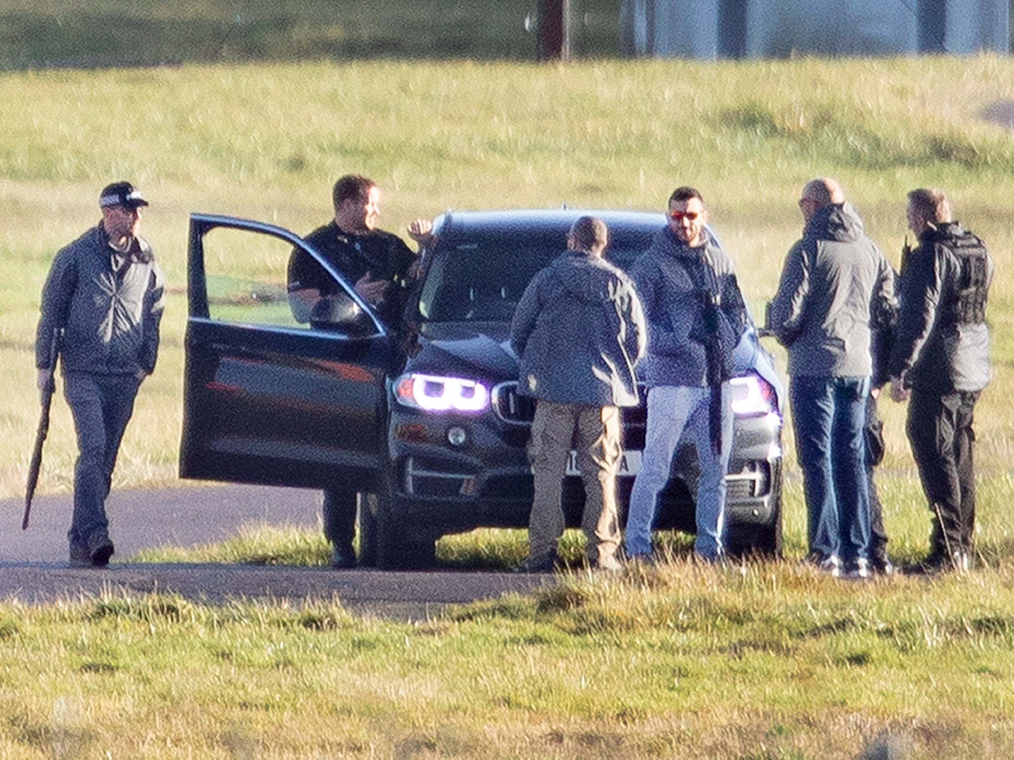 Armed police are seen next to the runway at Gatwick Airport