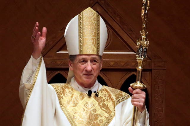 Archbishop Blase Cupich acknowledges after the retiring Cardinal Francis George presents the crozier during his Installation Mass at Holy Name Cathedral in Chicago