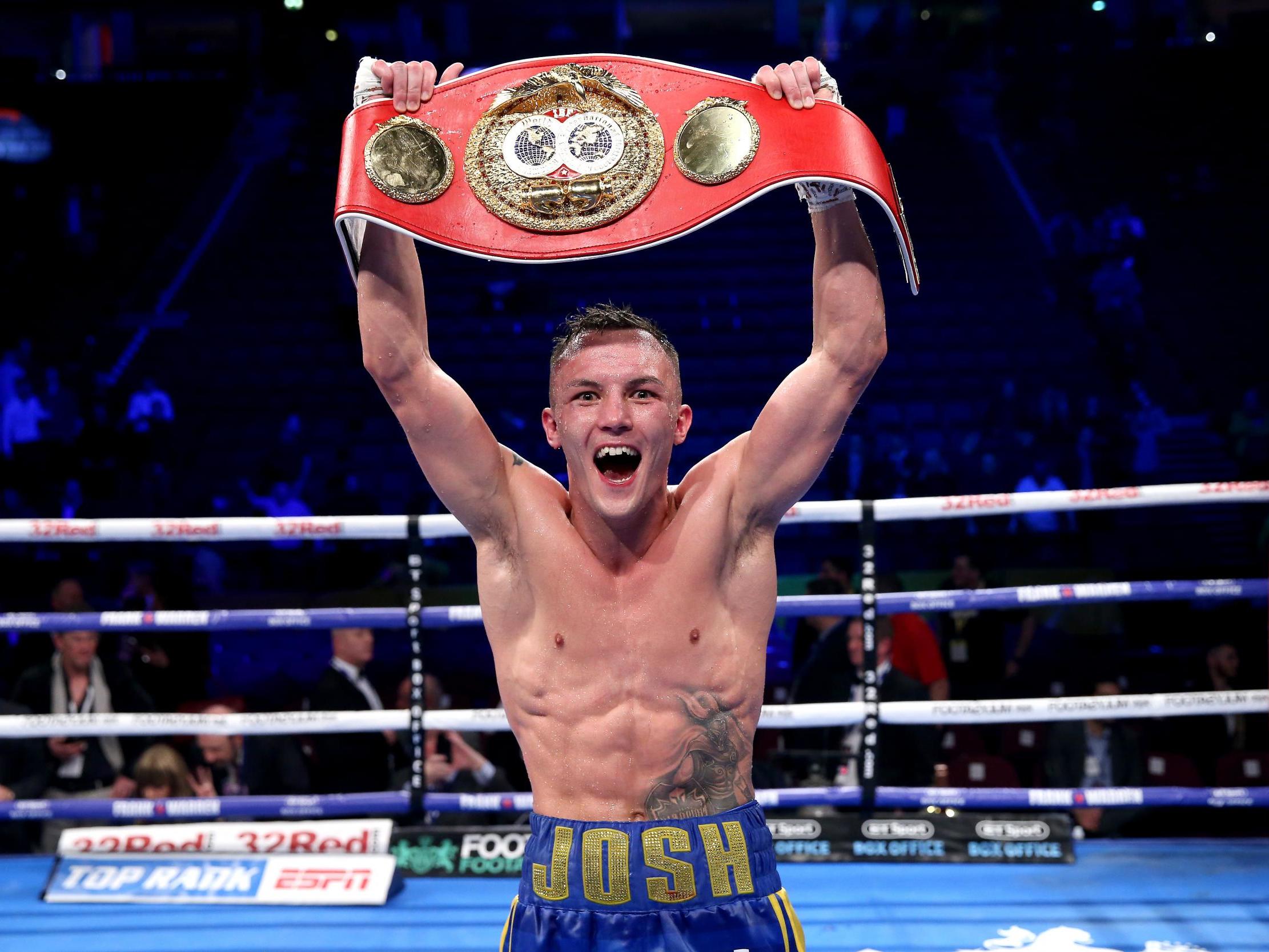 Warrington celebrates retaining the IBF featherweight title after beating Frampton