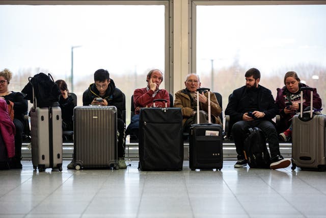 Passengers wait in the South Terminal building at London Gatwick Airport after flights resumed today on 21 December 21 2018