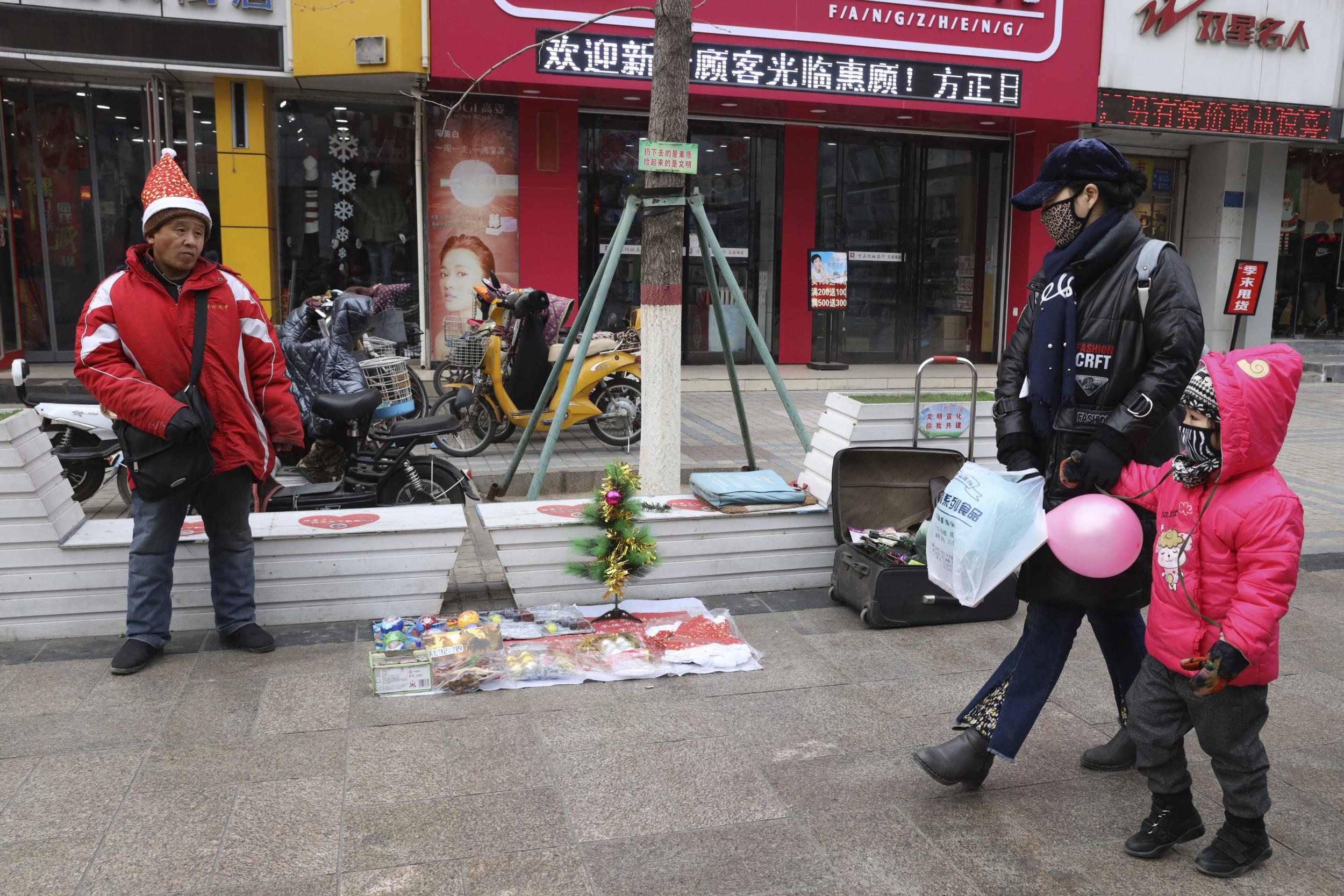 A man sells Christmas decorations on a street of Zhangjiakou in northern China's Hebei province