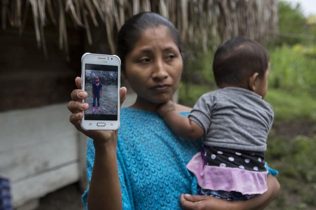 Claudia Maquin, 27, shows a photo of her daughter, Jakelin Amei Rosmery Caal Maquin in Raxruha, Guatemala, on Saturday 15 December 2018.