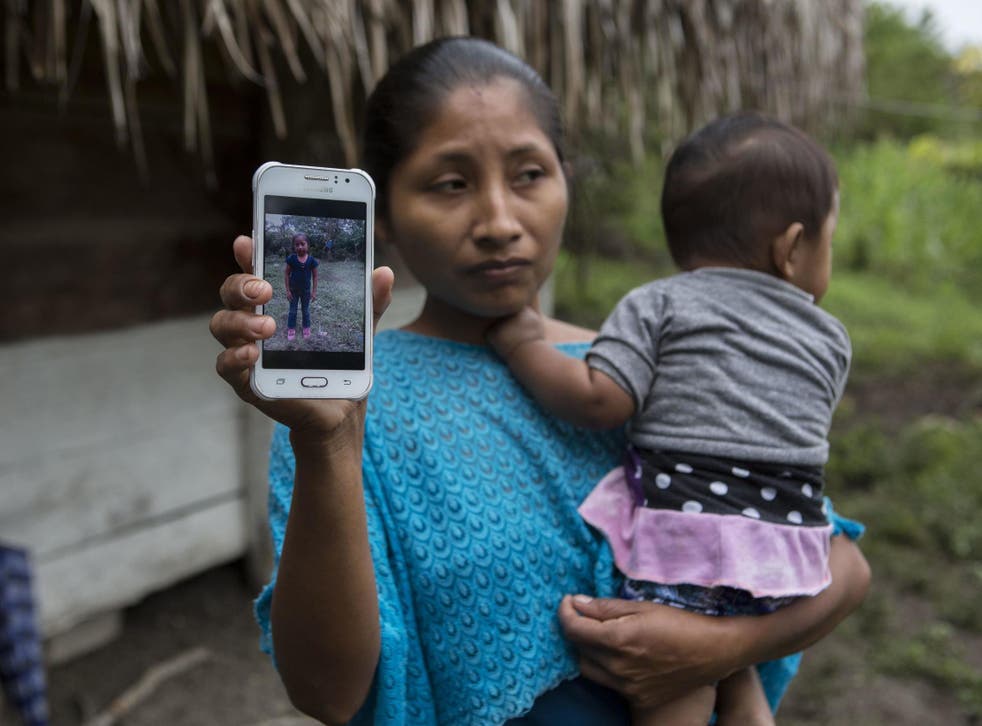 Claudia Maquin, 27, shows a photo of her daughter, Jakelin Amei Rosmery Caal Maquin in Raxruha, Guatemala, on Saturday 15 December 2018.