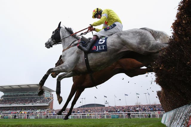 Politologue clears the last fence during the JLT Melling Chase on Ladies Day at Aintree