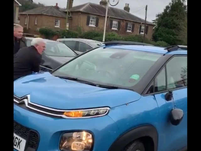 Two men ram blue Citroen C3 with trolleys and shout at them to get out of the car