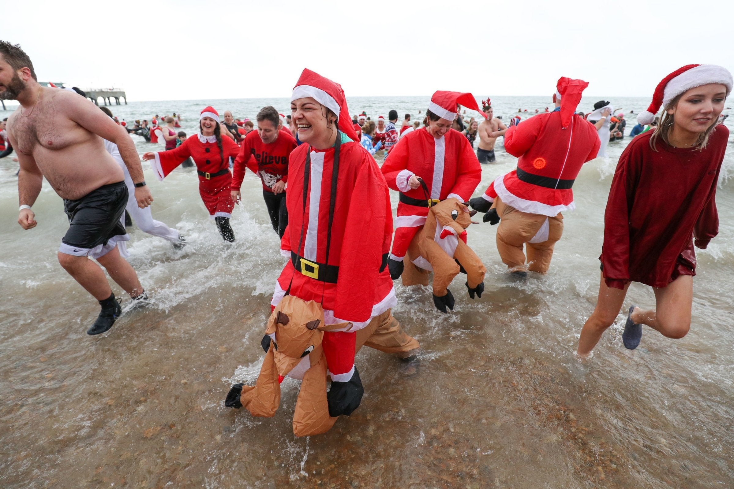 Swimmers dressed in full Santa Claus outfits for the annual swim at?Boscombe Pier in Bournemouth(PA)