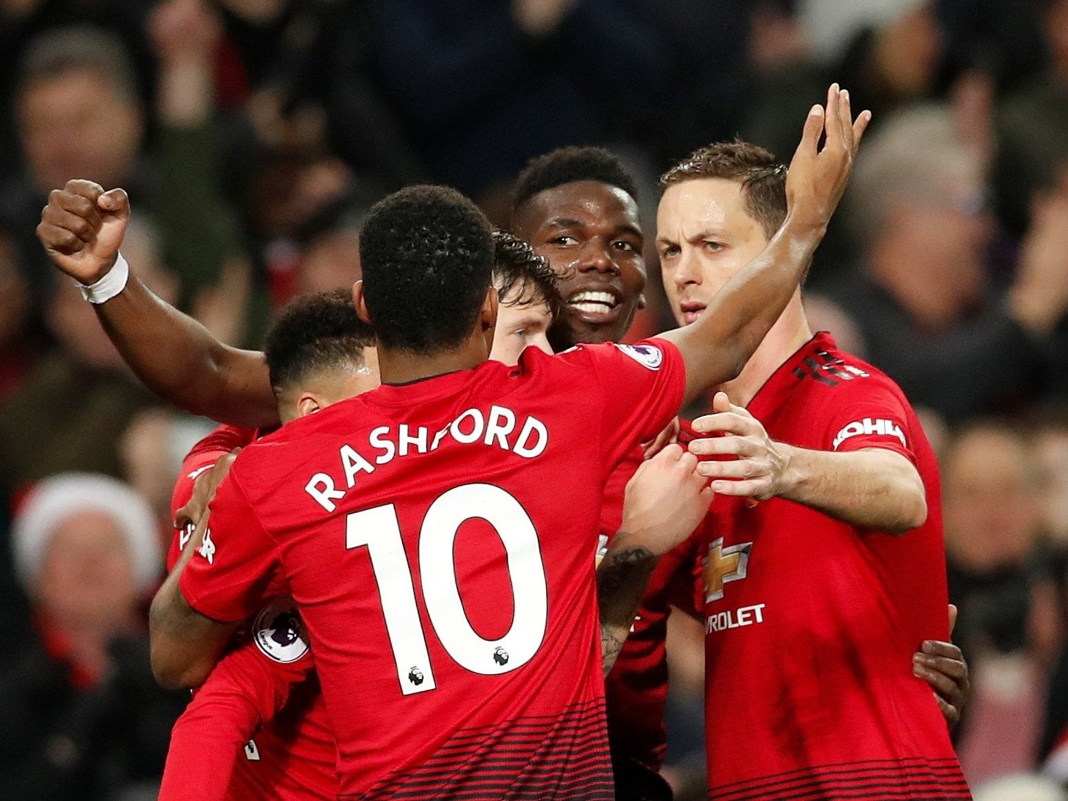Pogba celebrates with his United teammates after scoring against Huddersfield