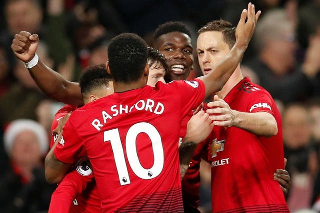 Paul Pogba celebrates with his Manchester United teammates after scoring against Huddersfield