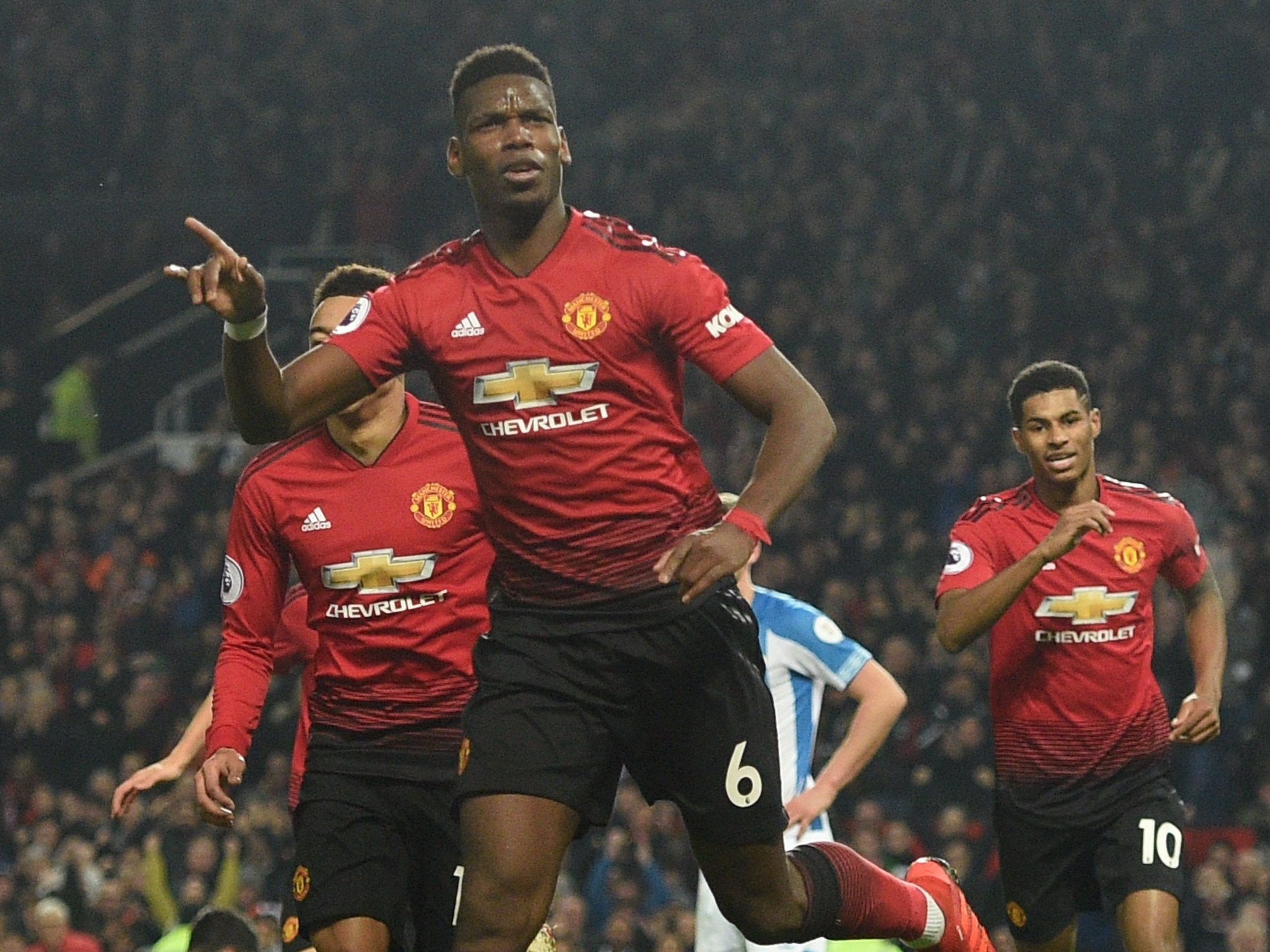 Paul Pogba celebrates after netting his second goal against Huddersfield