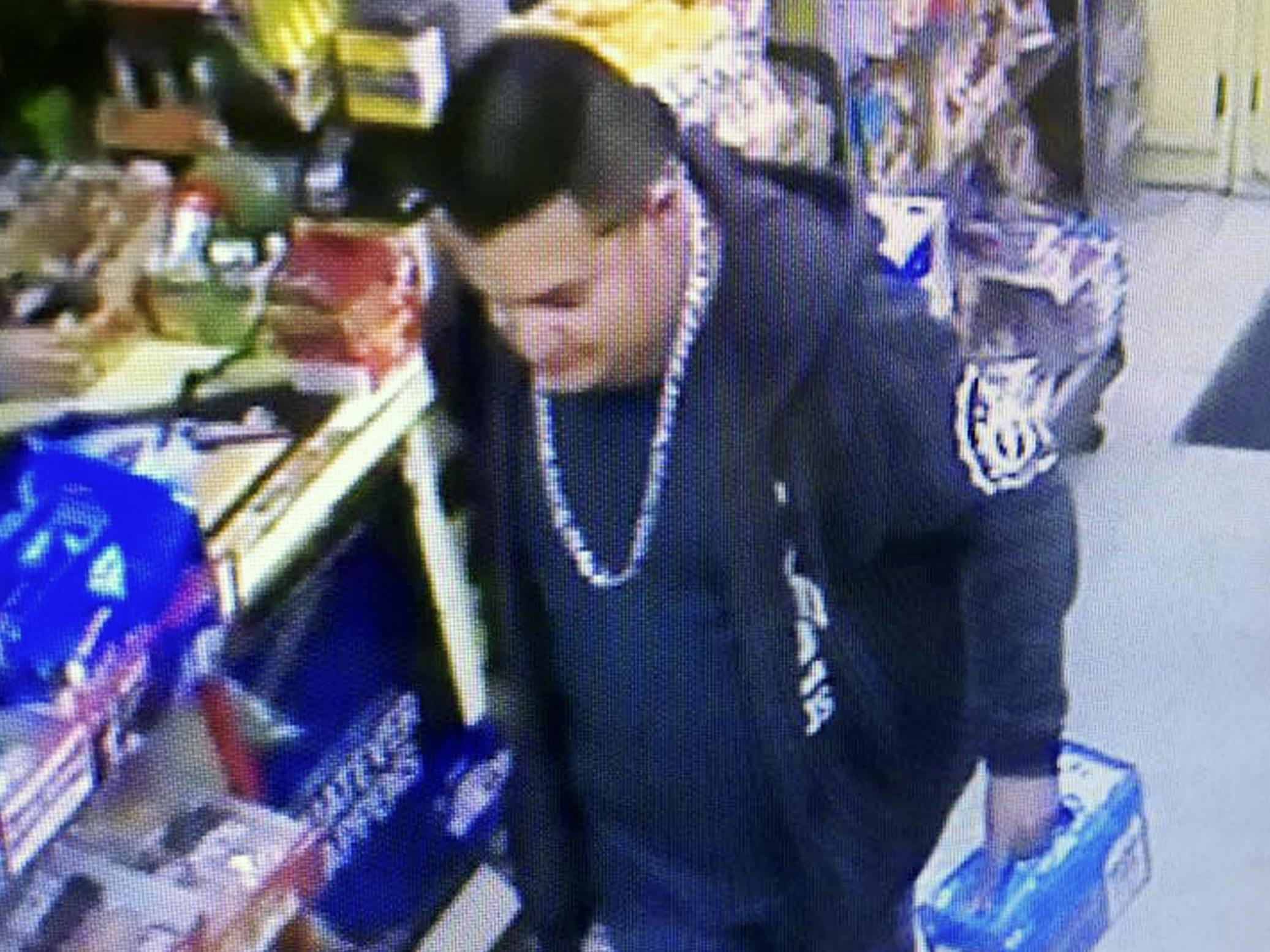 This image from a surveillance camera video shows a suspect connected to the fatal shooting of an officer