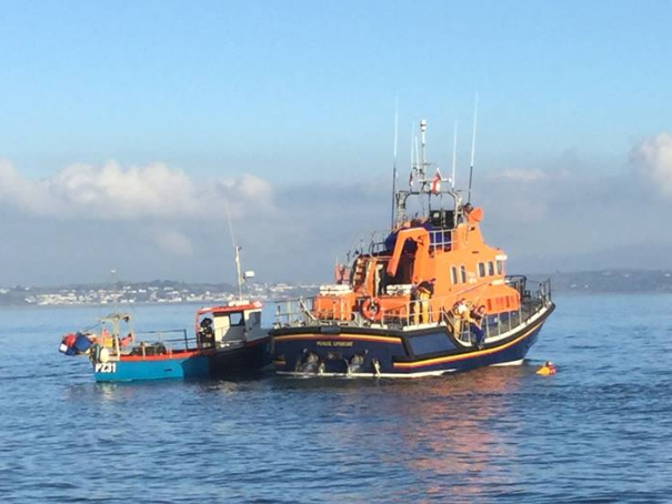 The Ivan Ellen Lifeboat picks up fisherman Nathan Rogers after he was pulled from the sea by the captain of another small vessel