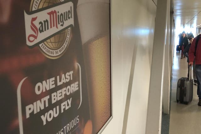Last orders: San Miguel poster at Stansted urging passengers to have 'one last pint before you fly'