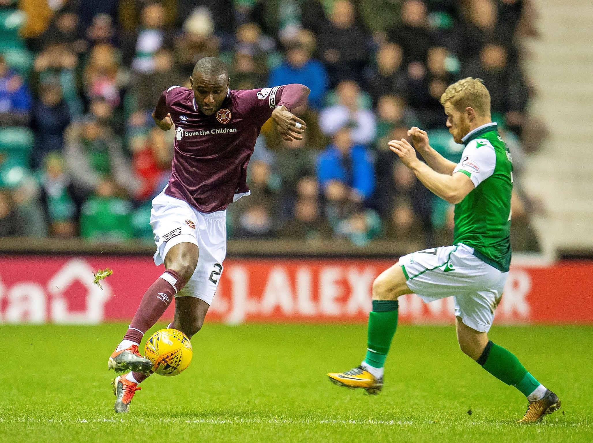 Clevid Dikamona of Hearts takes on Daryl Horgan