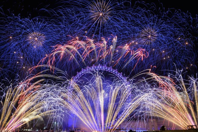 Fireworks light up the sky over the London Eye in central London during the New Year celebrations