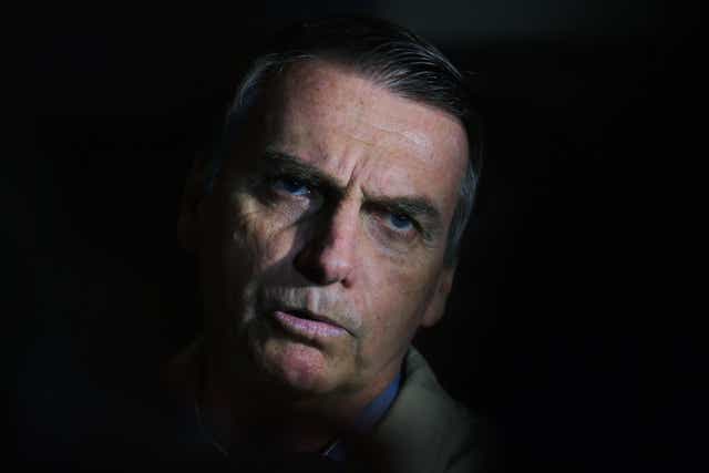 In this file picture taken on 17 October 2018 Brazilian far-right presidential candidate Jair Bolsonaro speaks to the press