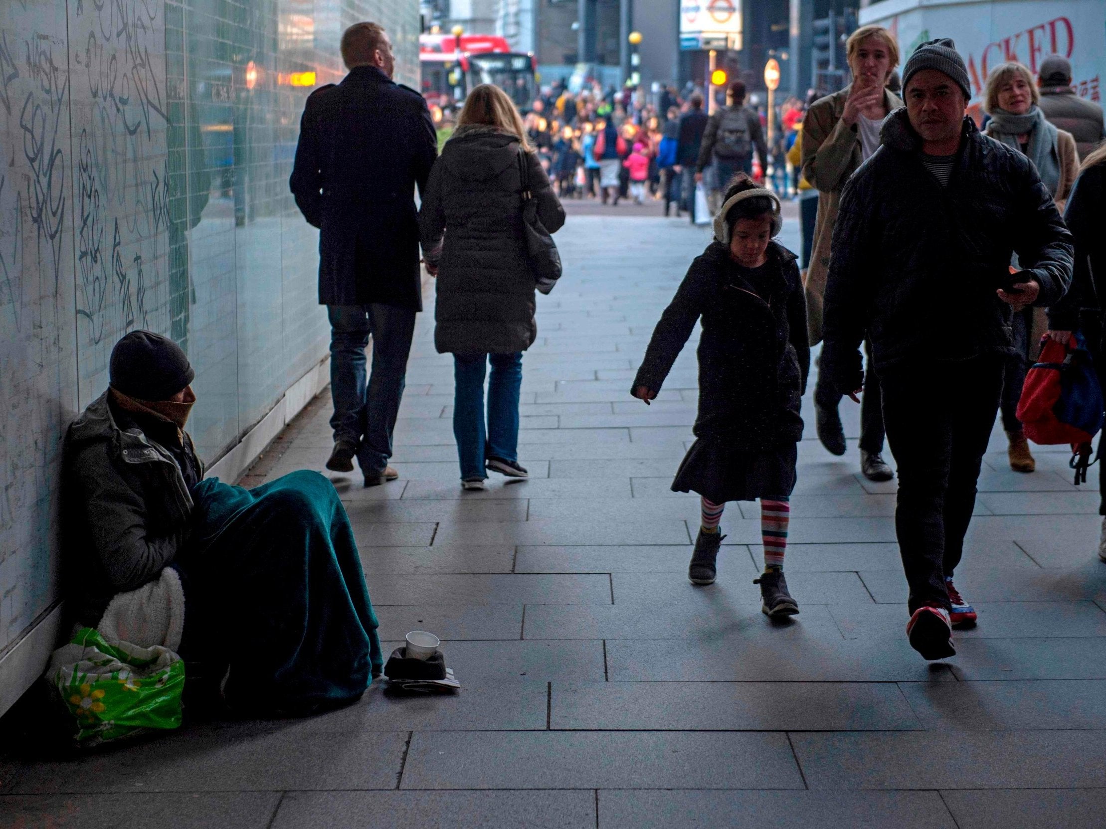 A homeless man sits in an underpass near Waterloo station over Christmas