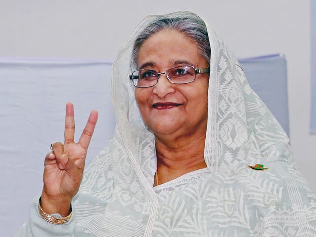 Bangladeshi prime minister Sheikh Hasina makes the victory signal after casting her vote at a polling station in Dhaka