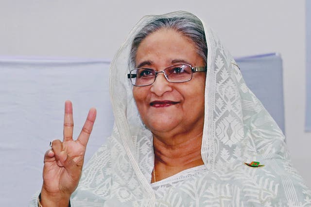 Bangladeshi prime minister Sheikh Hasina makes the victory signal after casting her vote at a polling station in Dhaka