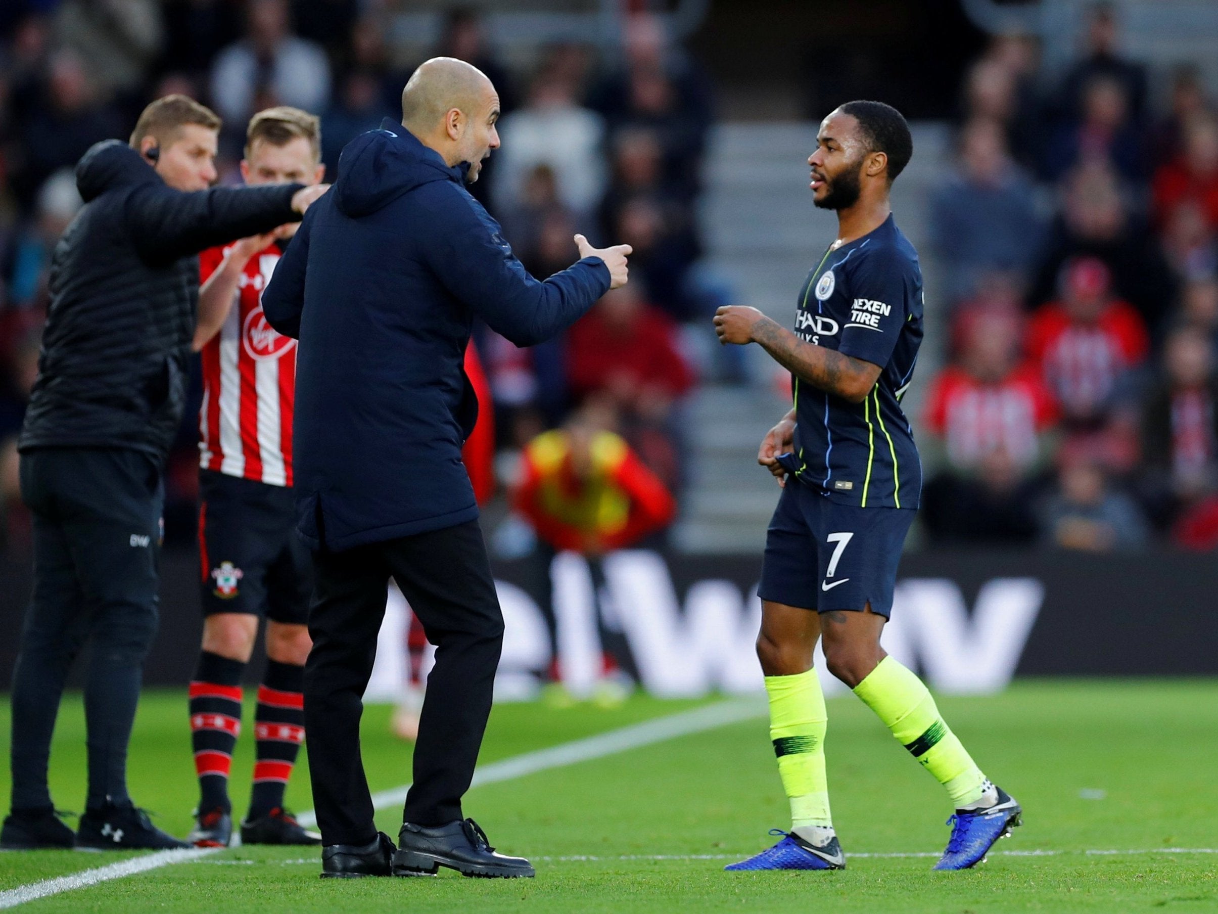 Raheem Sterling receives instructions from Pep Guardiola