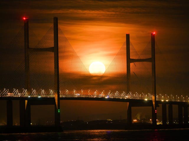 A Hunter's Moon setting over the Severn bridge between England and Wales in the Severn Estuary, 23 December