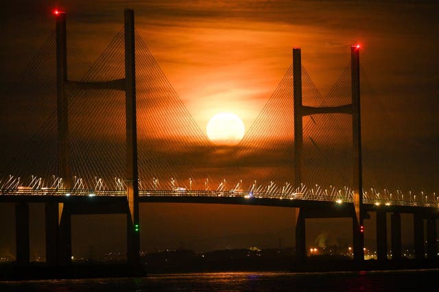 A Hunter's Moon setting over the Severn bridge between England and Wales in the Severn Estuary, 23 December