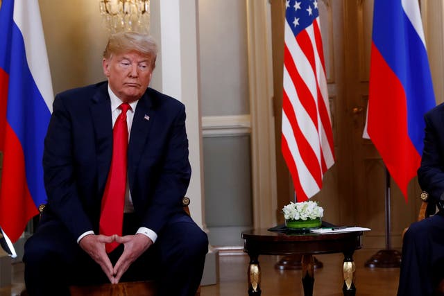 <p>Donald Trump sits with Russia’s president, Vladimir Putin </p>