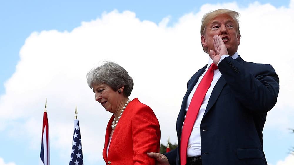 Reuters photographer Hannah McKay [Britain's Prime Minister Theresa May and U.S. President Donald Trump walk away after holding a joint news conference at Chequers)