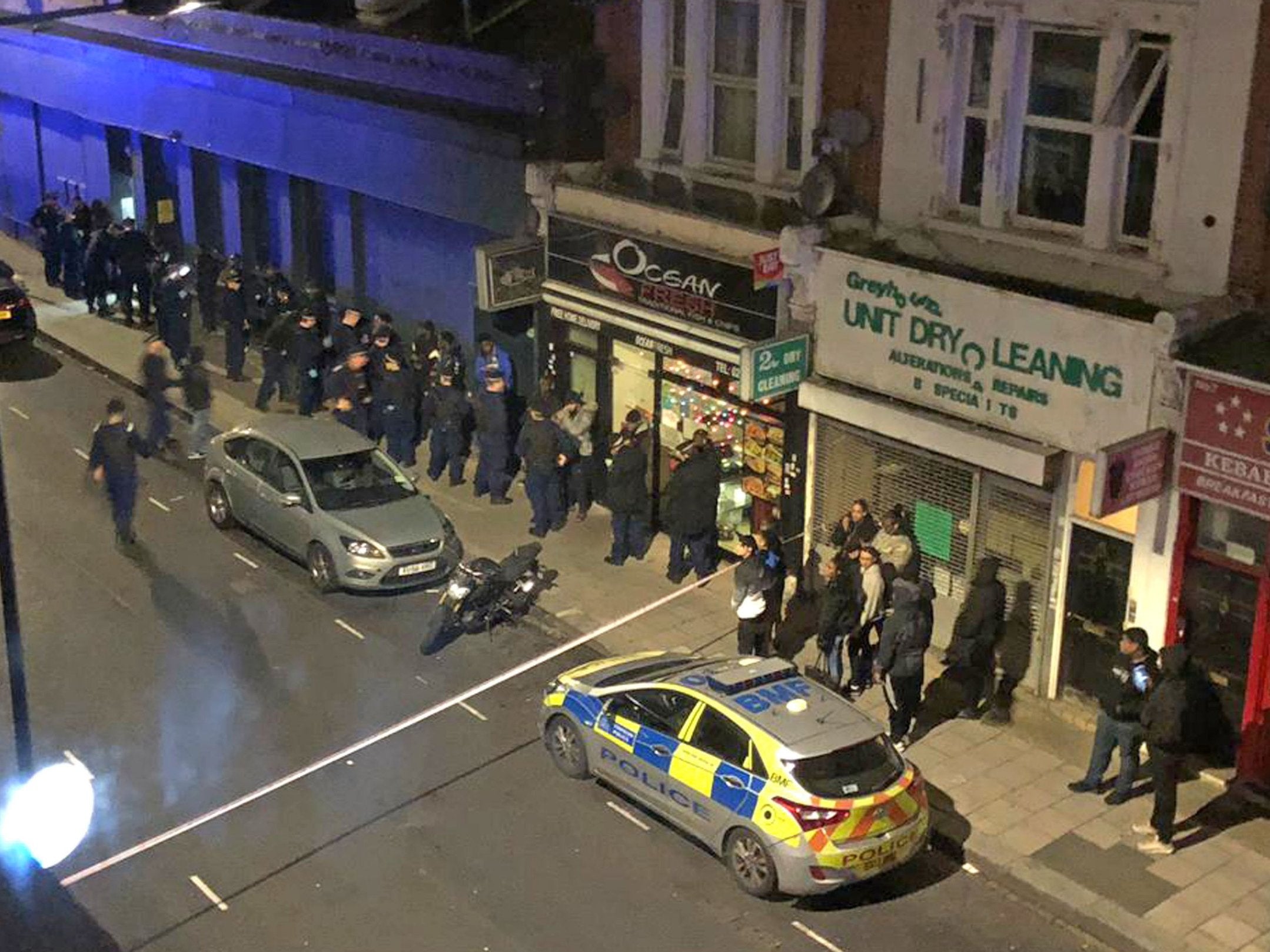 The scene opposite a property in Greyhound Road in Hammersmith, west London where thirty-nine people were arrested on suspicion of attempted murder following an incident on Fulham Palace Road