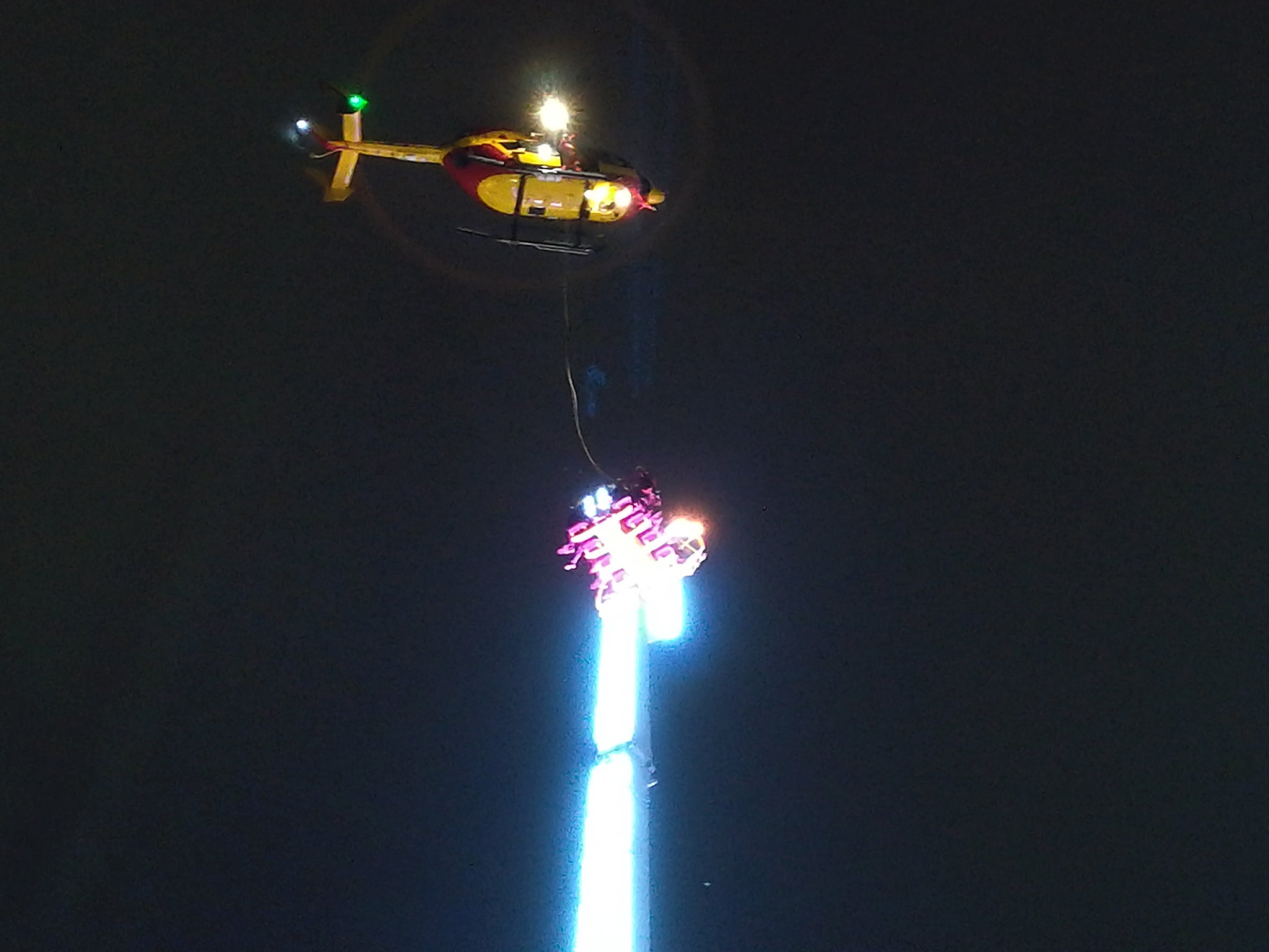 A helicopter hovers over the funfair ride late on New Year’s Eve
