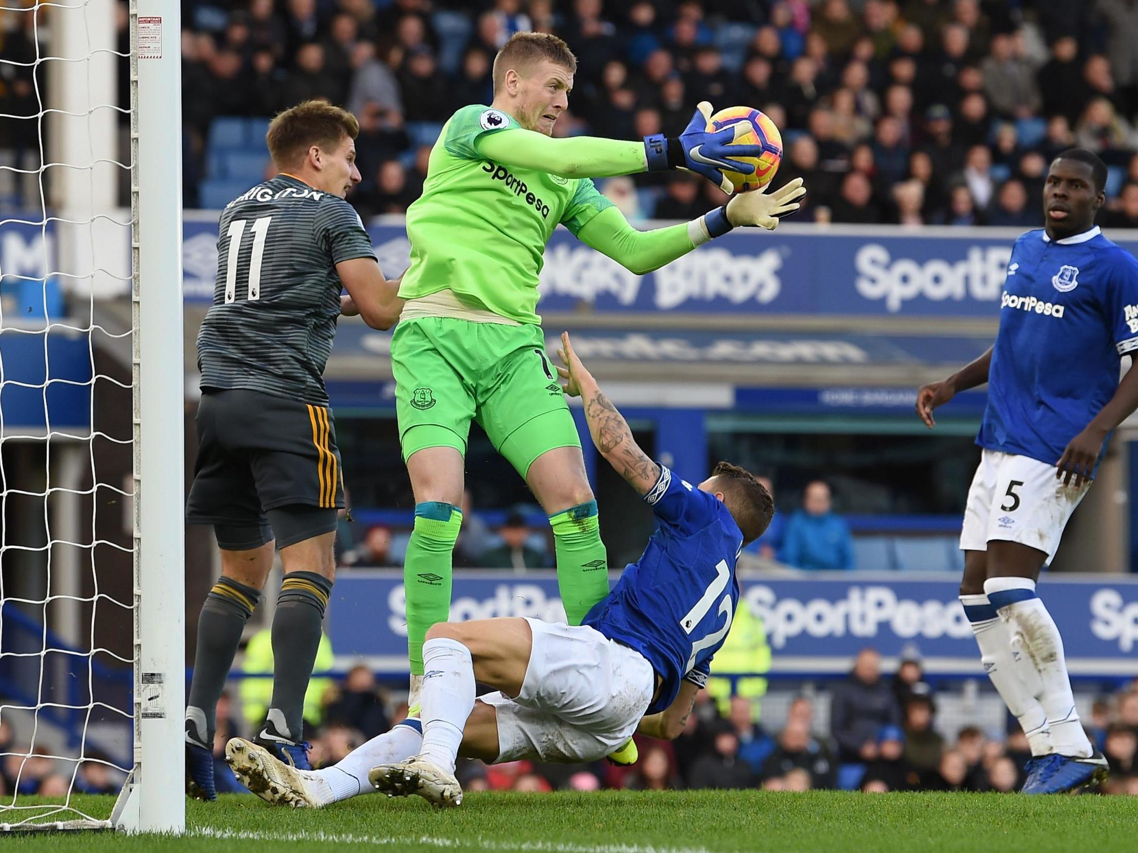 Jordan Pickford collects the ball under pressure from a Leicester attack
