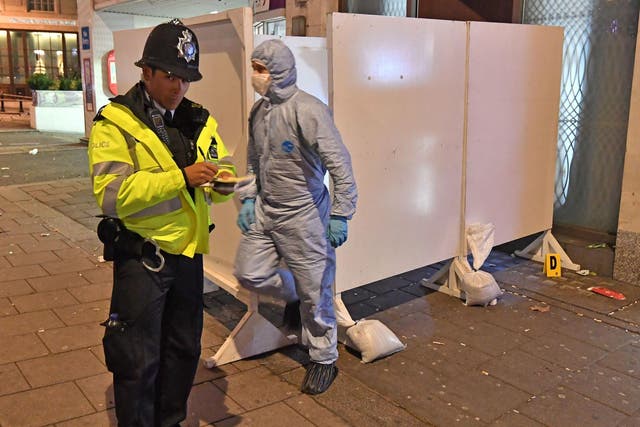 Police and forensic investigators in Park Lane, Westminster, where a security guard was stabbed to death outside a party