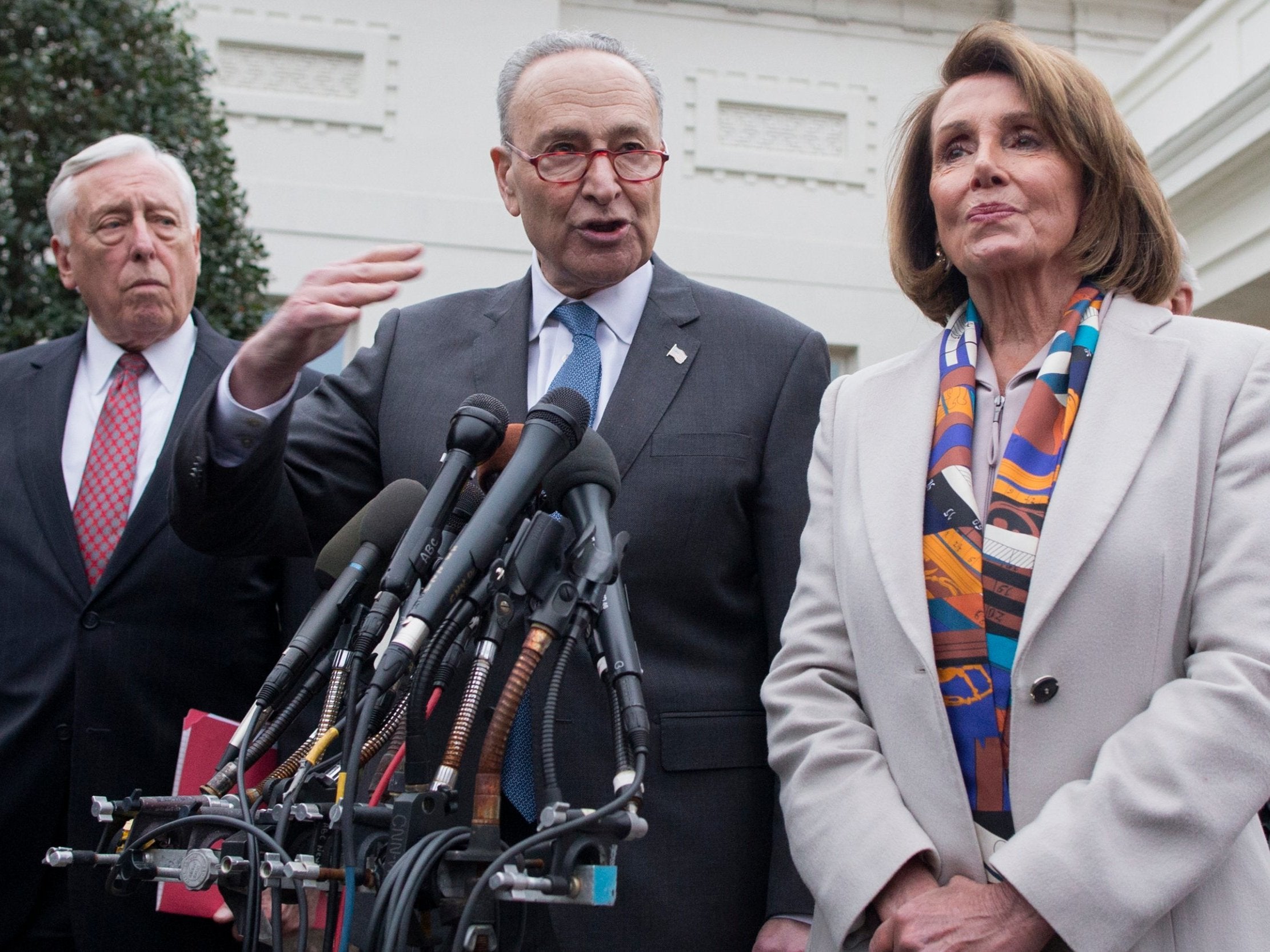 Chuck Schumer (centre) and Nancy Pelosi speak to reporters after the meeting