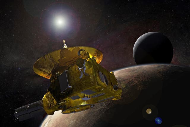 A handout photo made available by NASA shows an artist's concept of the New Horizons spacecraft as it approaches Pluto and its largest moon, Charon, in July 2015