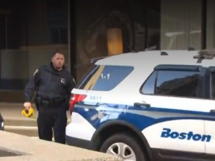 A police officer outside the Boston court where a man was stabbed during a fight.