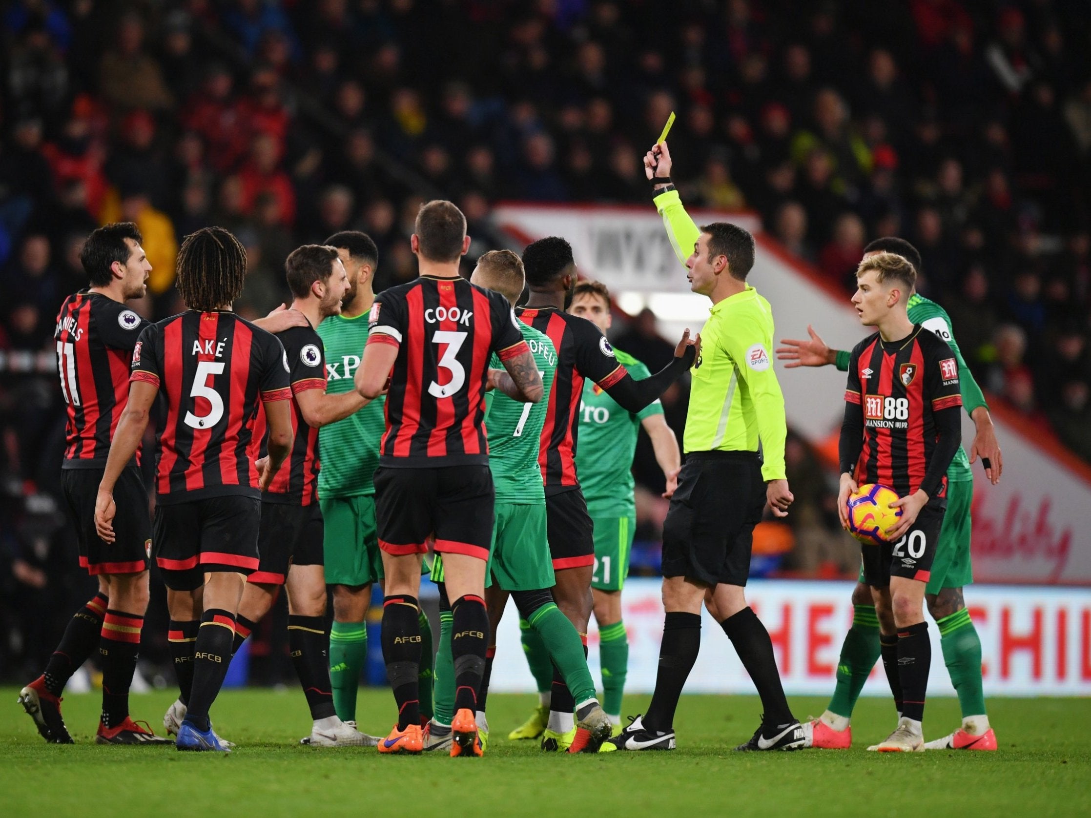 Dan Gosling was shown a yellow card for a strong tackle on Watford's Tom Cleverley