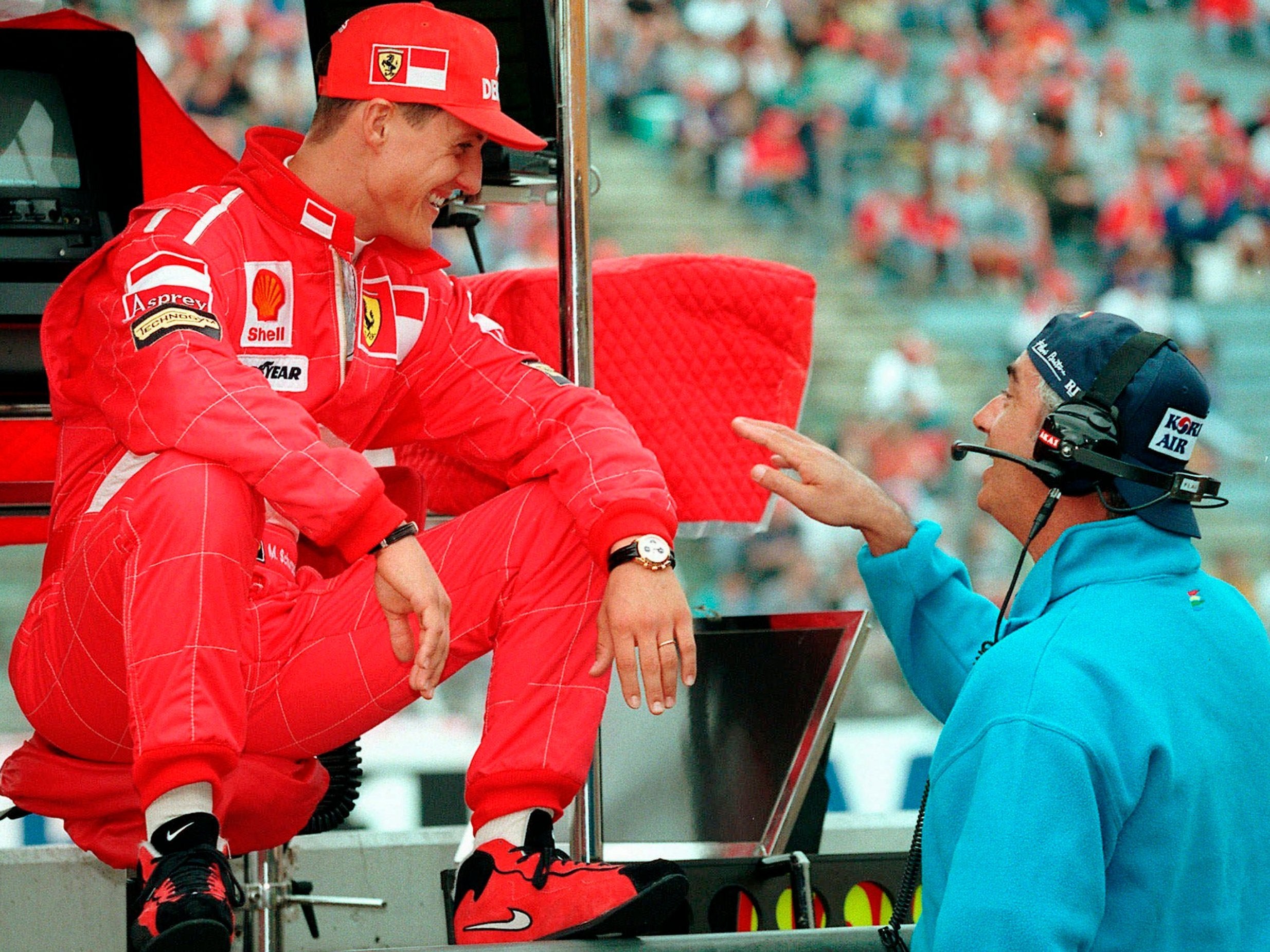 Schumacher shares a joke with his former boss Flavio Briatore