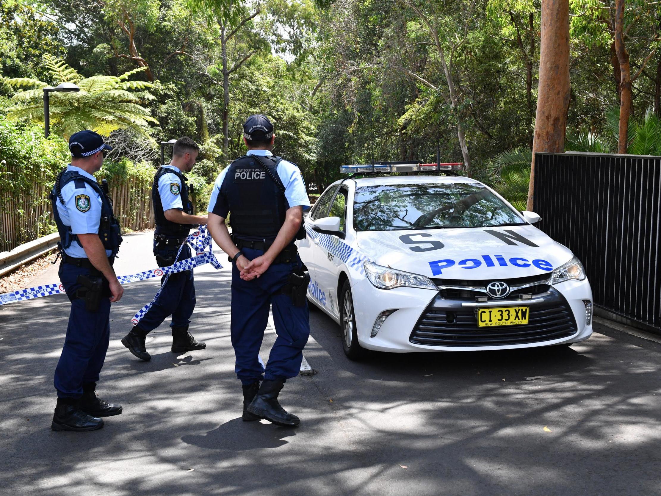 Police stand guard at the scene outside Scientology's Australian headquarters in Sydney after a fatal stabbing