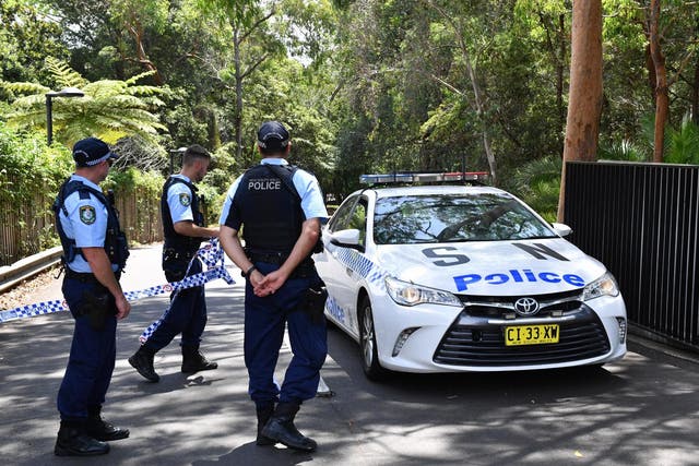 Police stand guard at the scene outside Scientology's Australian headquarters in Sydney after a fatal stabbing