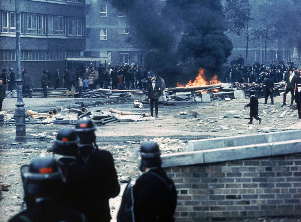 The Bogside, 12 August 1969: police watch from a distance as crowds gather around a fire (Getty)