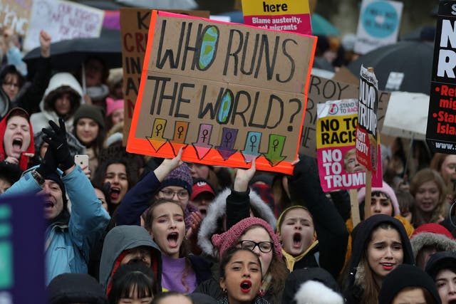 Protesters hold up placards during the Women's March in London on 21 January 2018 as part of a global day of protests