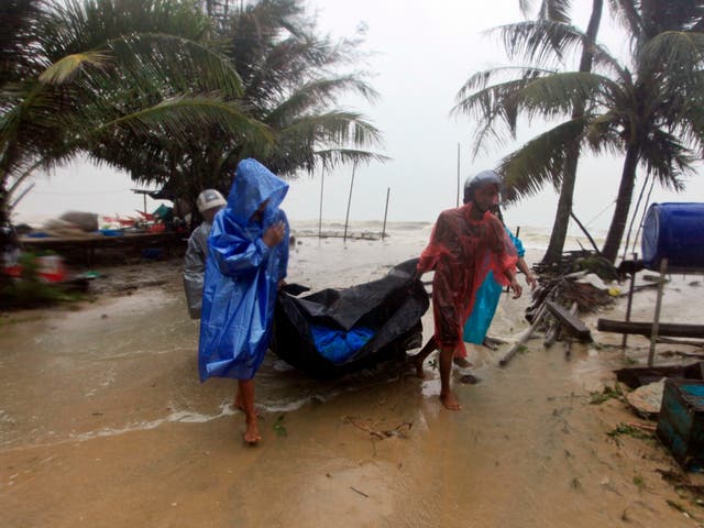 Thai locals clear the shoreline as Tropical Storm Pabuk makes landfall in Pak Phanang in the southern province of Nakhon Si Thammarat