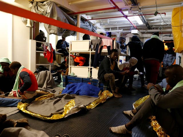 Migrants rest on the migrant search and rescue ship Sea-Watch 3, operated by German NGO Sea-Watch, off the coast of Malta in the central Mediterranean Sea 3 January, 2019.