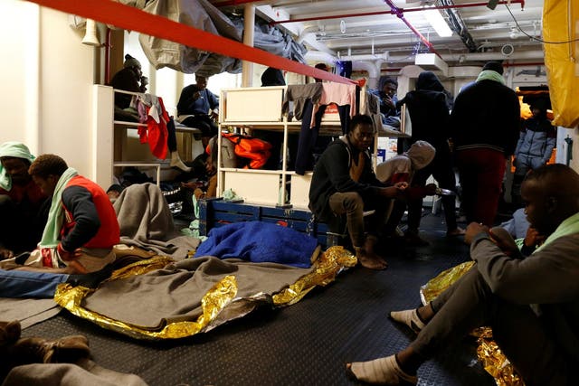 Migrants rest on the migrant search and rescue ship Sea-Watch 3, operated by German NGO Sea-Watch, off the coast of Malta in the central Mediterranean Sea 3 January, 2019.
