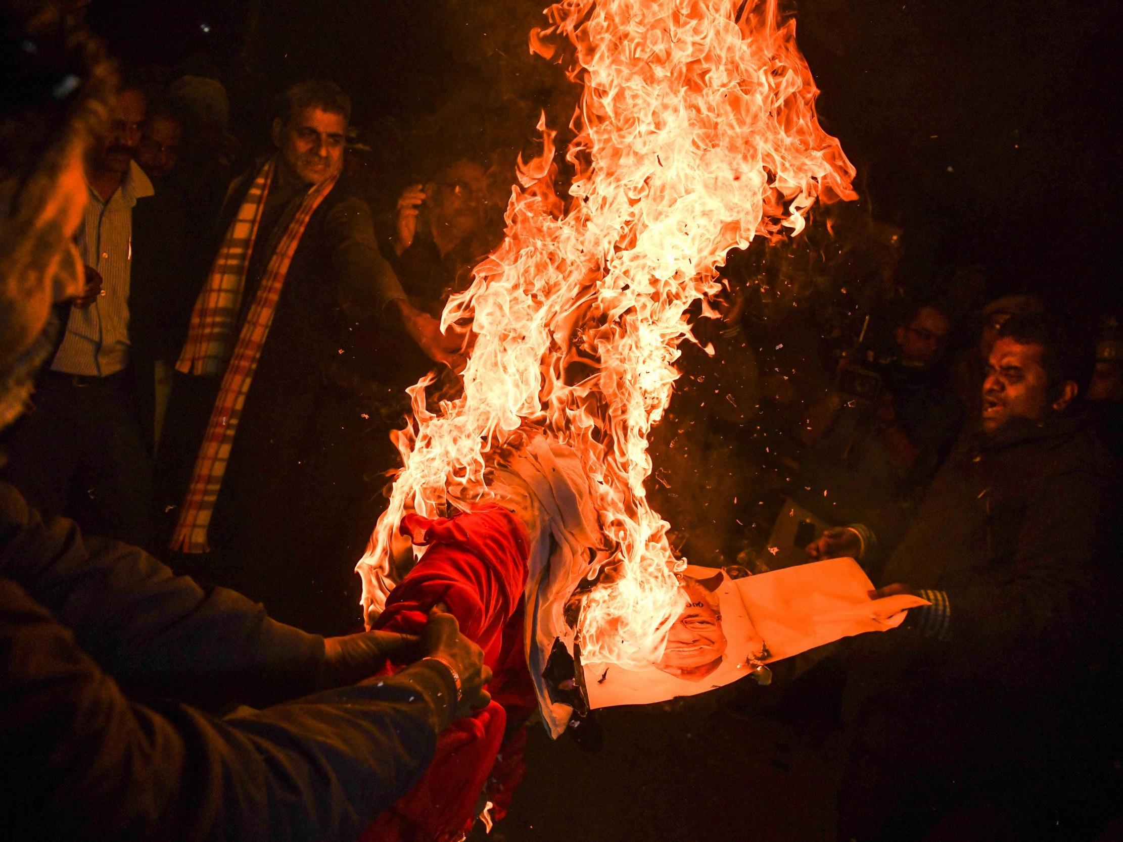 Indian Hindu activists burn an effigy during a demonstration