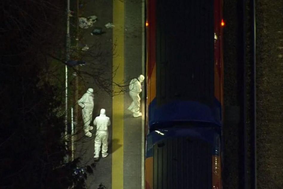 Police forensic investigators board a train at Horsley station after a man was stabbed to death