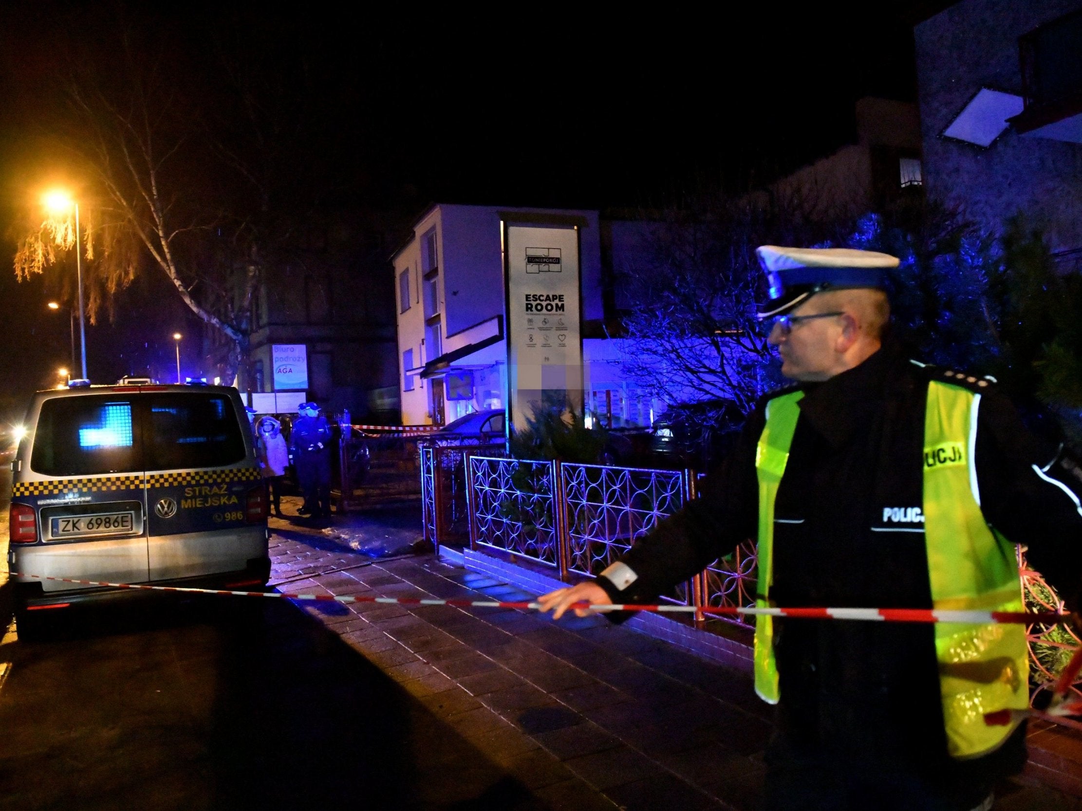 Emergency services cordon off the road outside the escape room in Koszalin where the girls died
