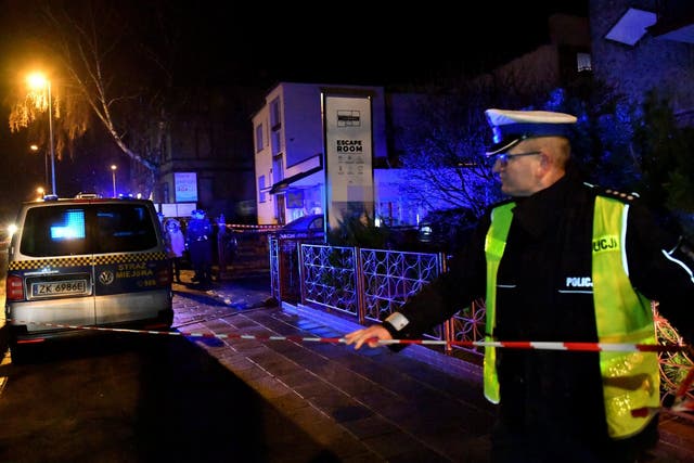 Emergency services cordon off the road outside the escape room in Koszalin where the girls died