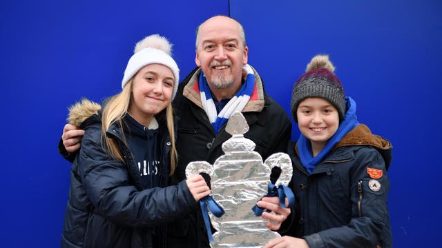 Fans pose with a homemade FA Cup trophy
