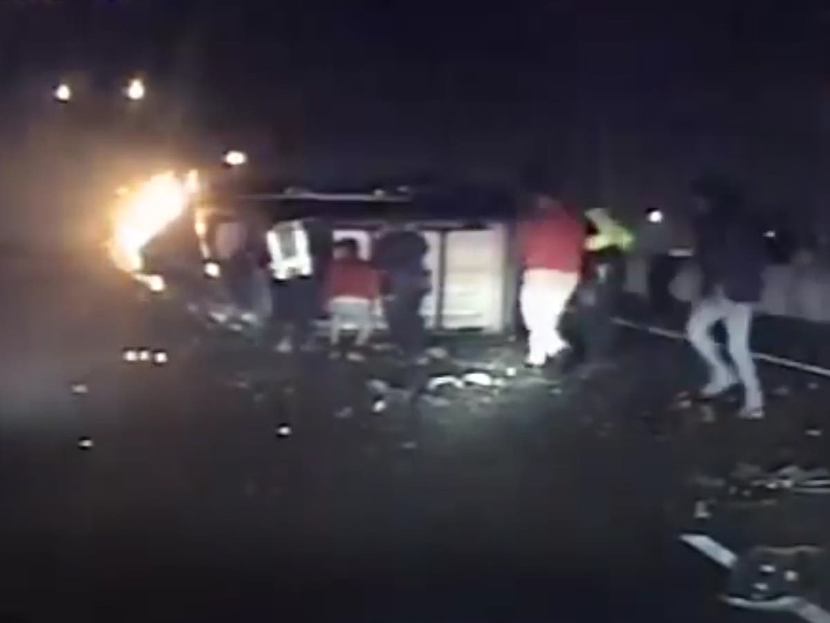 Police and passersby rush to save elderly man from overturned burning ...